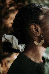 brass hoops with a botanical imprint